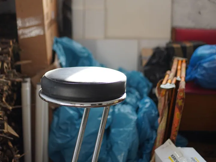 Stored boxes and unwanted items in a cluttered garage