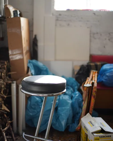 Stored boxes and unwanted items in a cluttered garage