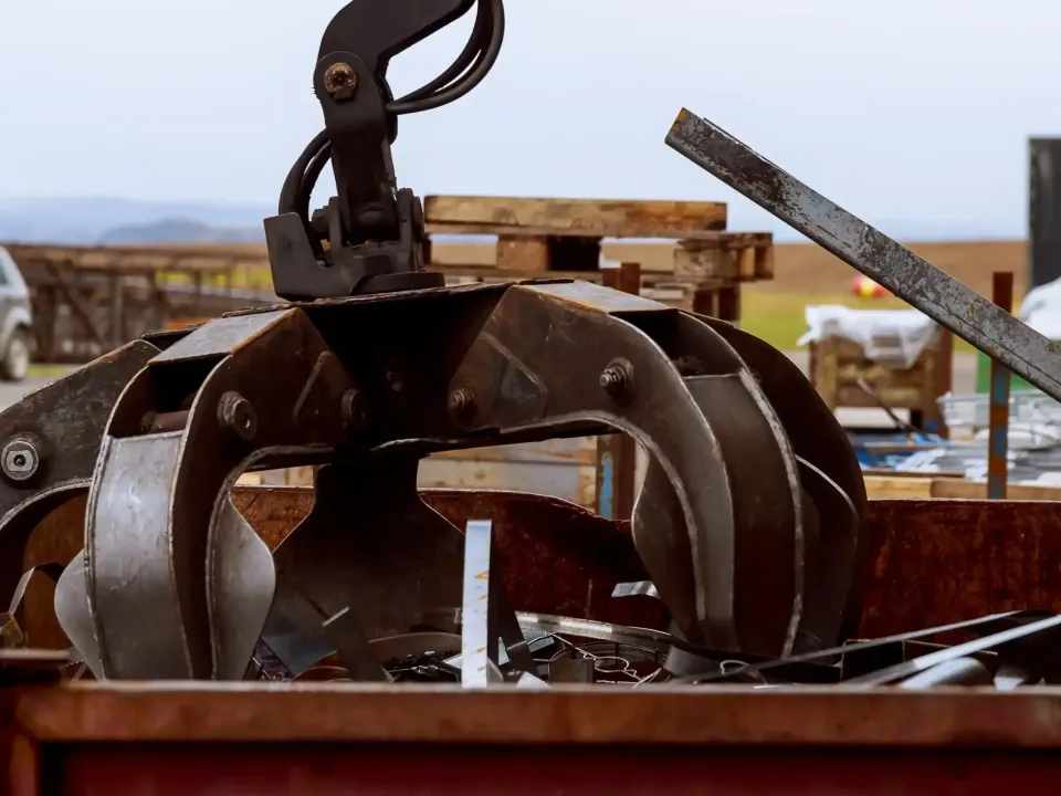 Mechanical grab lifting scrap metal at a materials yard