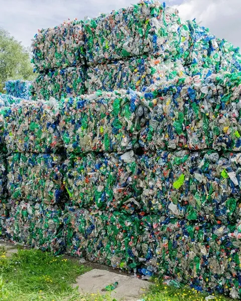 Stacked bales of mixed plastic material at a recycling site